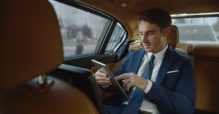 smiling-male-professional-reading-good-news-tablet-computer-automobile smiling-male-professional-reading-good-news-tablet-computer-automobile